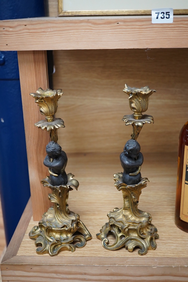 A pair of decorative French ormolu figural candlesticks, 25.5cm high